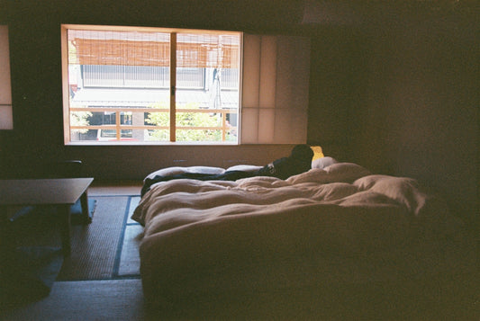 A minimalist bedroom with a futon.