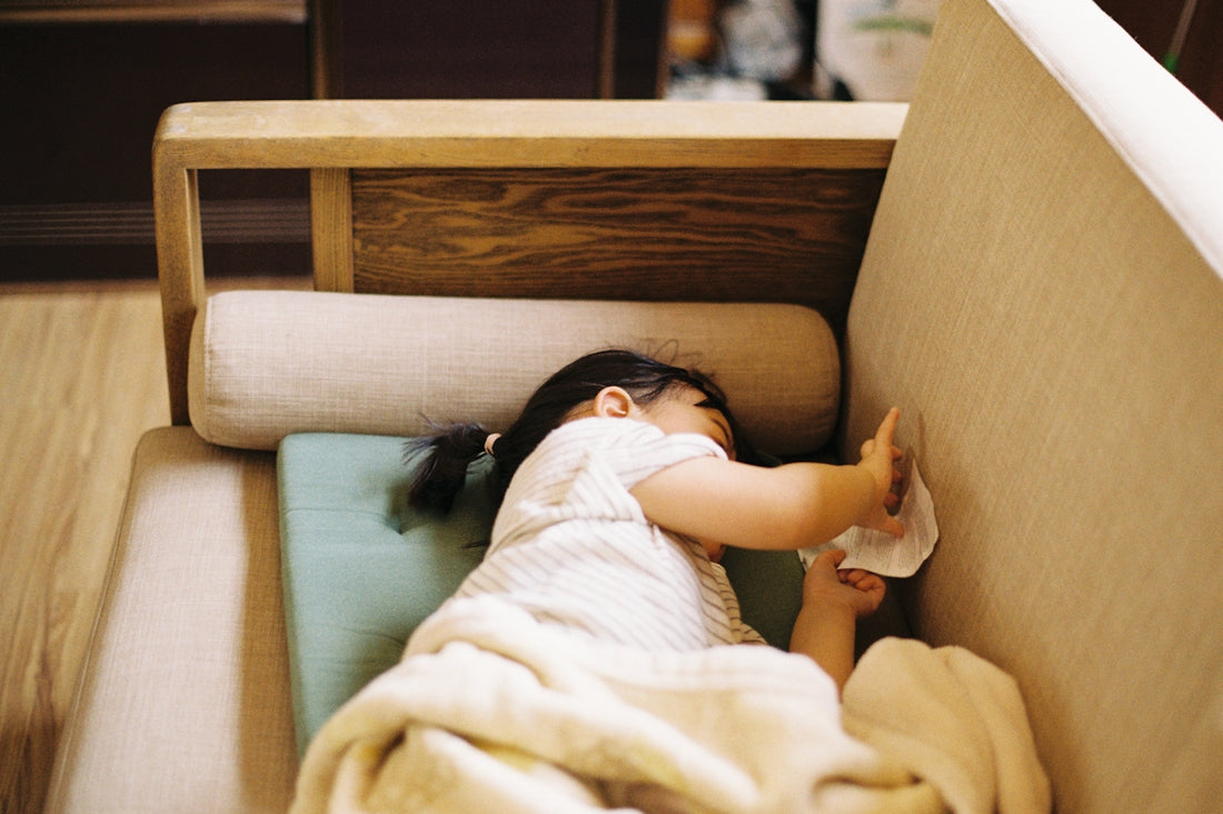 girl in white shirt lying on bed