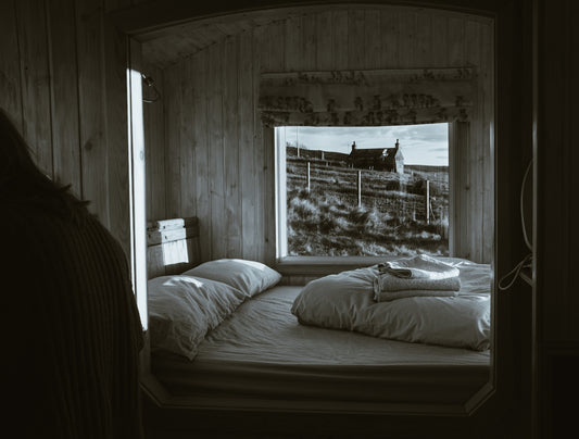 grayscale photo of bed with pillows