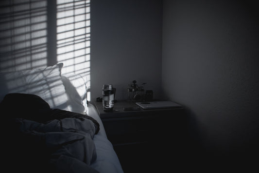 a person's shadow is cast on the wall of a bedroom