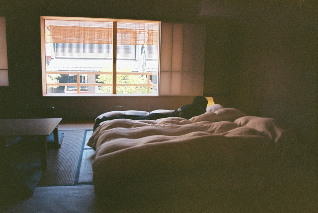 A minimalist bedroom with a futon.
