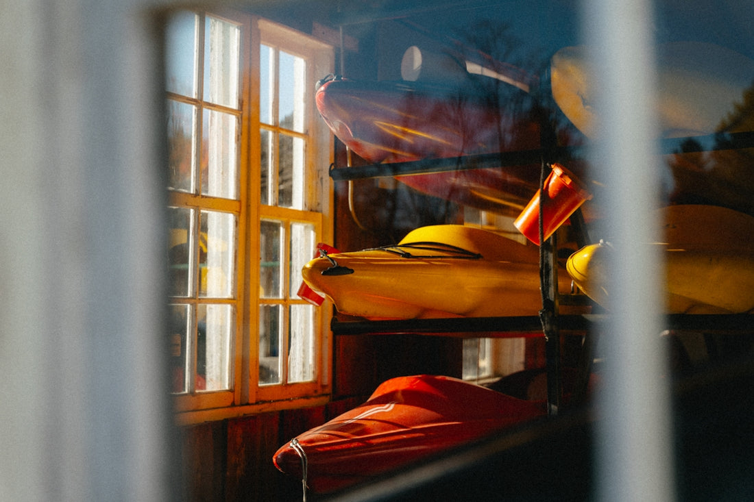 Kayaks stored indoors near a window